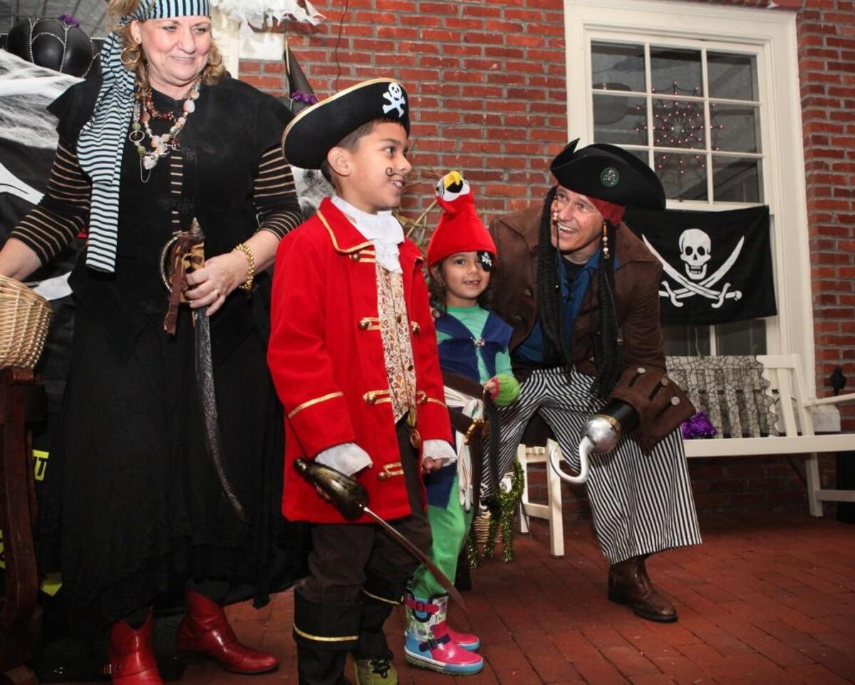 Gov. Jay Inslee and first lady Trudi Inslee greet fellow pirates Paul Manwiller, 8, and his sister, Claudia Manwiller, 6, during the annual Halloween night trick-or-treating at the Governor’s Mansion in 2013.