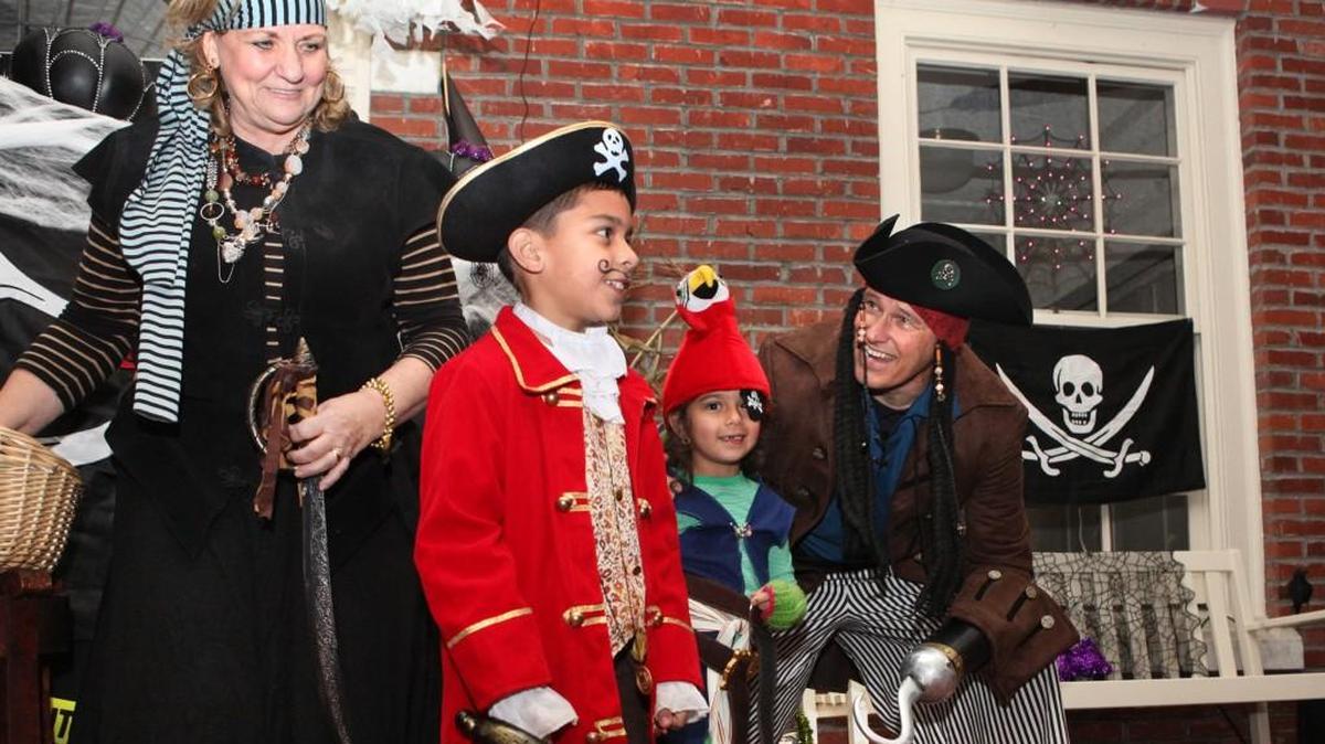 Gov. Jay Inslee and first lady Trudi Inslee greet fellow pirates Paul Manwiller, 8, and his sister, Claudia Manwiller, 6, during the 2013 Halloween night trick-or-treating at the Governor’s Mansion. This year, the governor will be costumed to celebrate Sonics basketball.