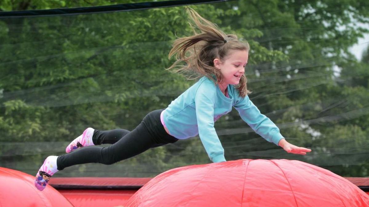 Madison Gault, 7, of Lacey flies through the “Leaps & Bounds” obstacle course during the two-day Lacey Spring Fun Fair in 2015. The Fun Fair starts Saturday.