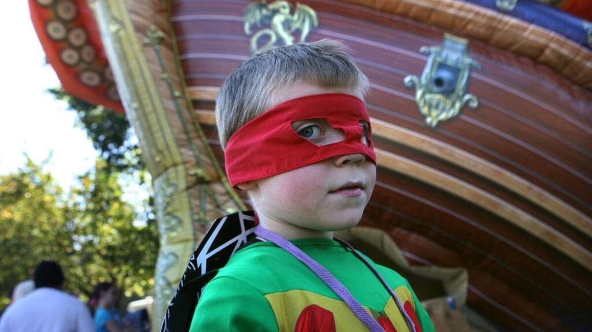 Damon McDermitt of Lacey prowls the games and bounce houses in his Ninja Turtle costume during the 2012 Lacey Children’s Day celebration at Huntamer Park. The one-day celebration returns this weekend.