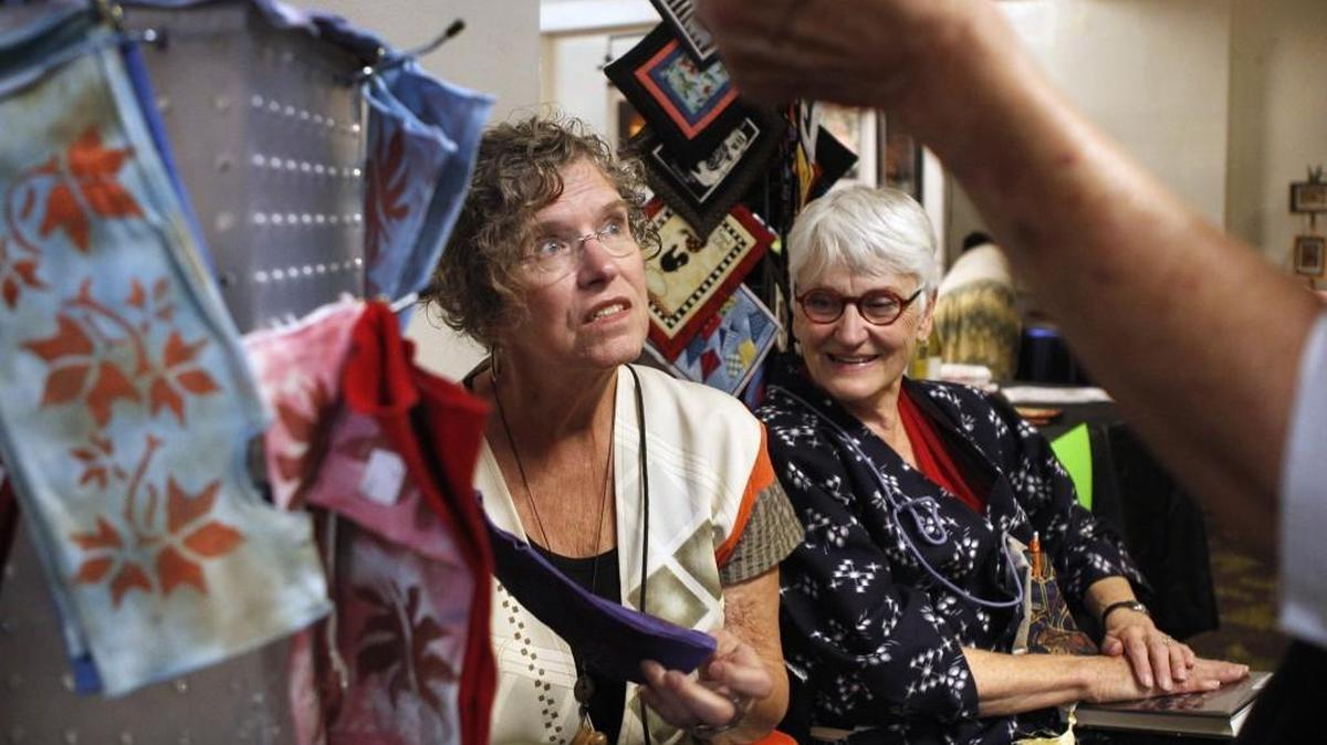 
Pam Wells (left) of Olympia and Eddi Baird of Lacey show their fabric art during Fall Arts Walk in downtown Olympia on Friday, Oct. 3, 2014. Wells hand dyes and decorates bamboo clothing. Baird does hand embroidery.

