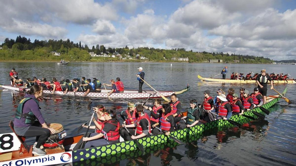 Dragon boats fill Budd Inlet as they take off for the staging area during the annual Saint Martin's University Dragon Boat Festival at the Port Plaza in Olympia in 2015.