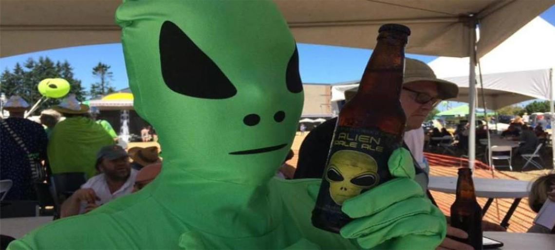 A festivalgoer dressed as an alien enjoys an Alien Pale Ale by Fish Brewing at a past UFO Fest in Washington.