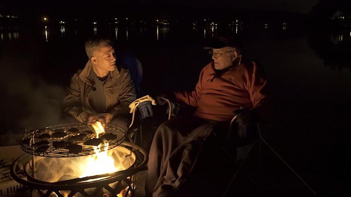 Patrick Yamashita talks to his father, Jerry Yamashita, and about family history while cooking oysters at Burley Lagoon.