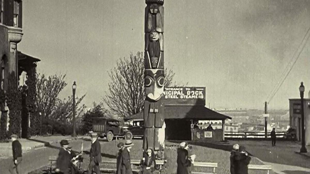 
Actor Wanda Hawley begs in front of the Tacoma totem pole in a scene from “Eyes of the Totem,” a silent film shot in Tacoma in 1926 and released in 1927.
