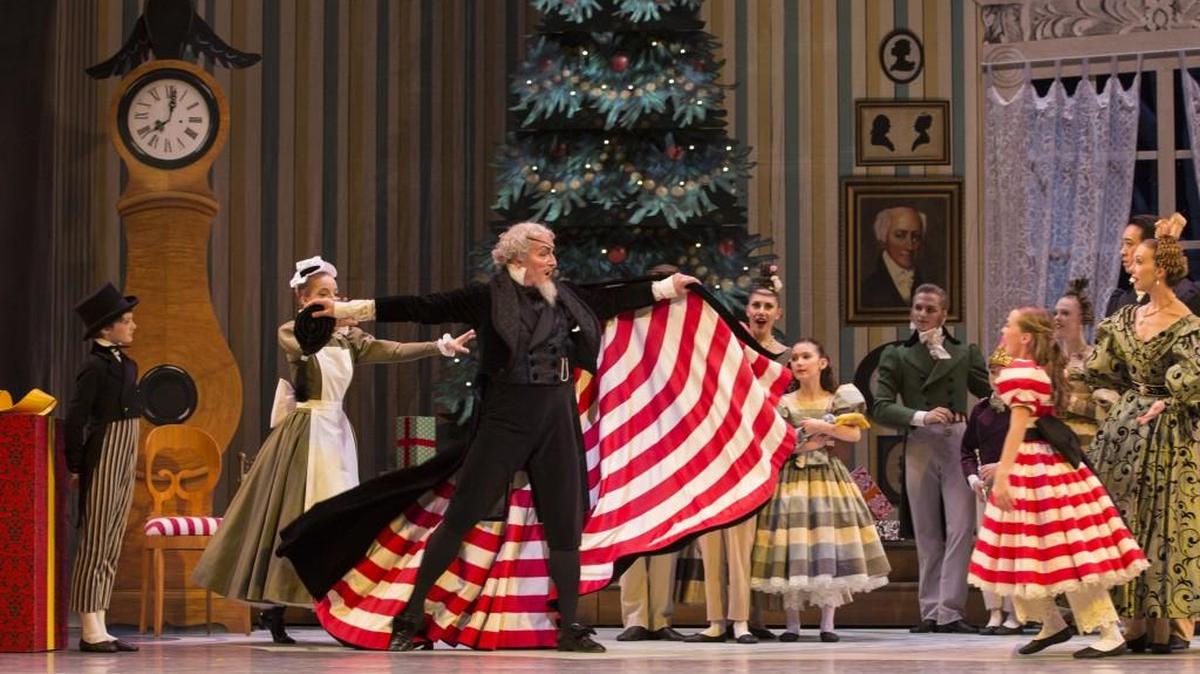 Pacific Northwest Ballet guest artist Uko Gorter as Drosselmeier and the ballet’s school student Isabelle Rookstool as Clara in George Balanchine’s “The Nutcracker.”