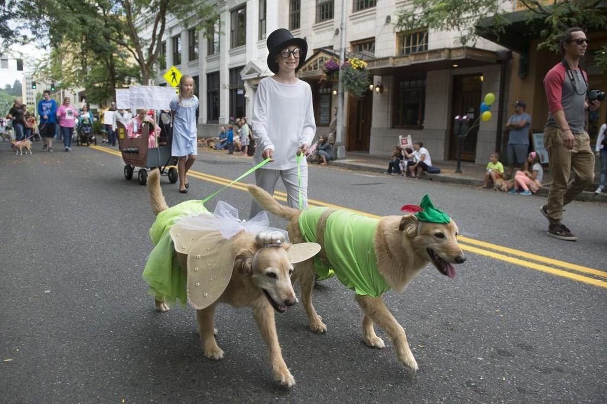 Natalie Gantenbein, 10, of Olympia walks golden retrievers Daisy and Dash with her family’s Peter Pan-themed entry in the 2017 annual Pet Parade in downtown Olympia.
