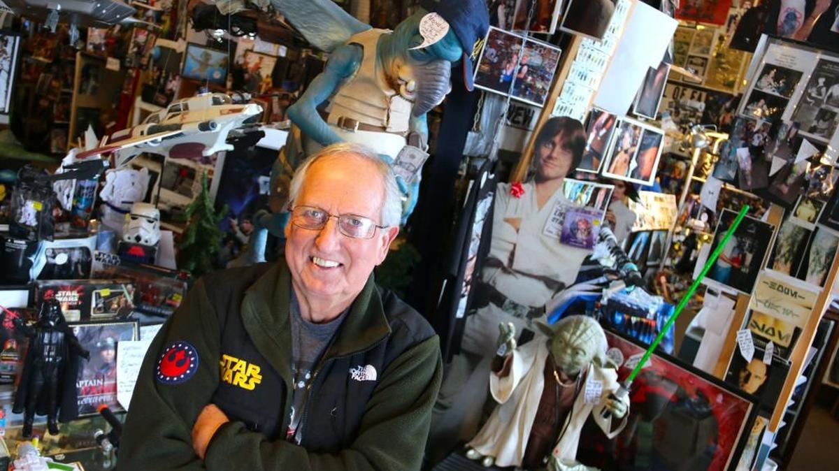 Don Sucher stand amid all the Star Wars toys and memorabilia that fill his Sucher and Sons Star Wars Shop in Aberdeen.