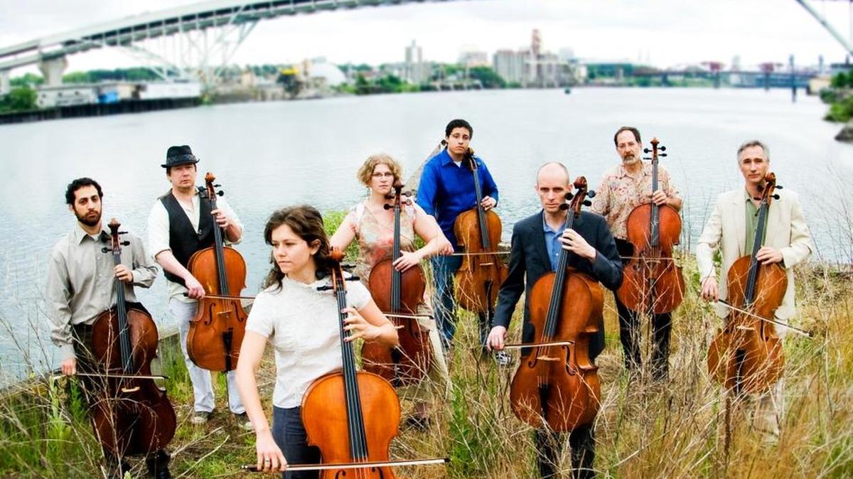 The Portland Cello Project, seen along the banks of the Willamette River with Portland’s Fremont Bridge in the background, is sett o play Olympia’s Washington Center for the Performing Arts at 7:30 p.m. Friday (Feb. 5).