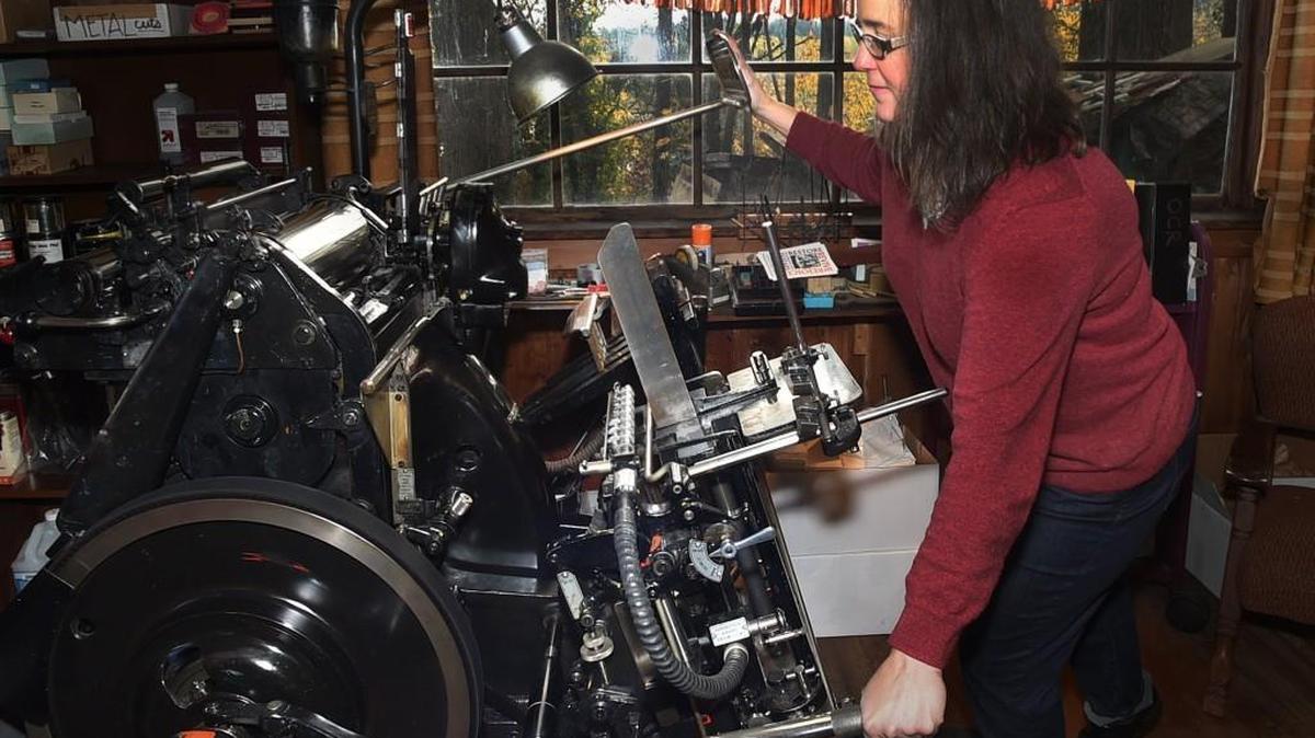 Sherwood Press owner Jami Heinricher fires up the vintage 1950s era Heidelberg printer for a quick demonstration. The Press is holding an open house Saturday to celebrate its 75th anniversary.