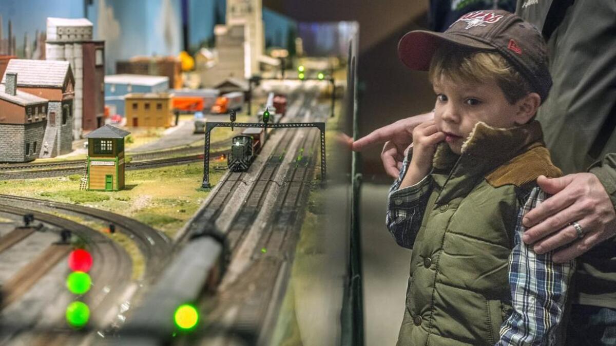 Rapt and in a model train moment of his own, Owen Rash of Tacoma looks over an HO scale model layout during the 2014 Model Train Festival show at the Washington State History Museum. This year’s show opens Saturday.