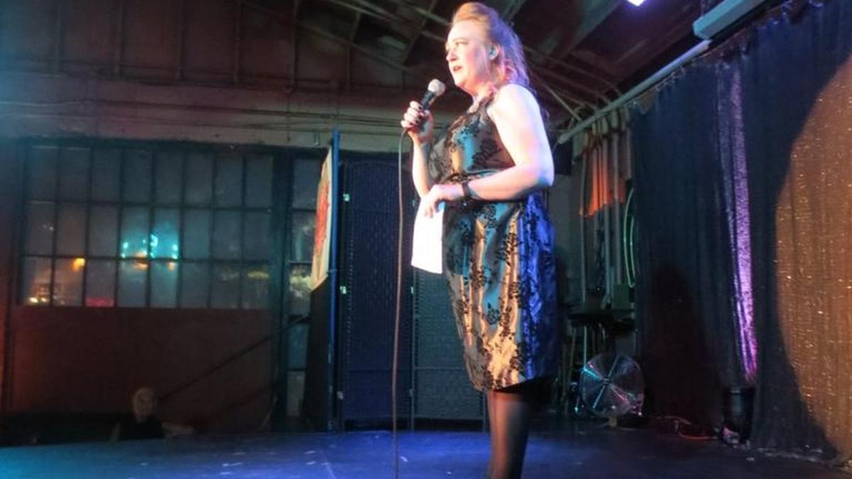 StoryOly host Elizabeth Lord on stage at the recent Love Seats event, a collaboration between Story Oly and Rocky Candy Burlesque, at Rhythm & Rye in Olympia.