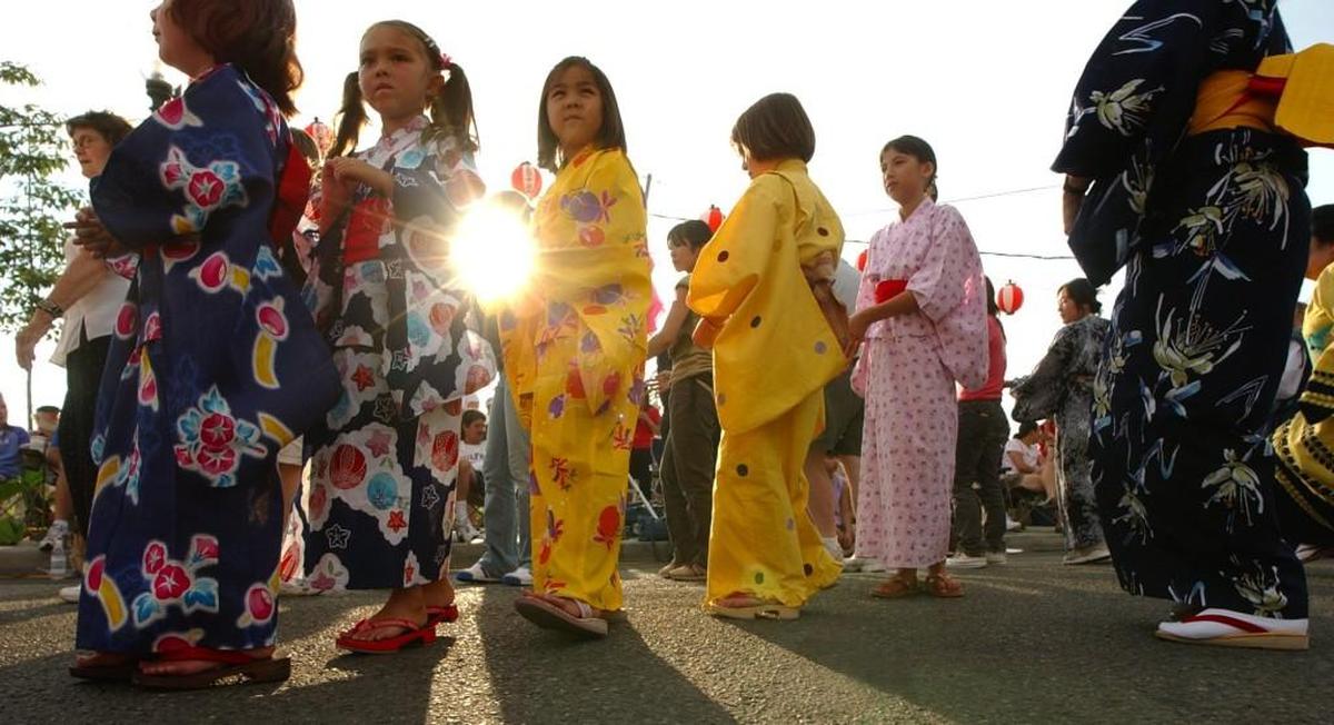 Dancers flow past the setting sun at a past Bon Odori Festival in downtown Olympia.