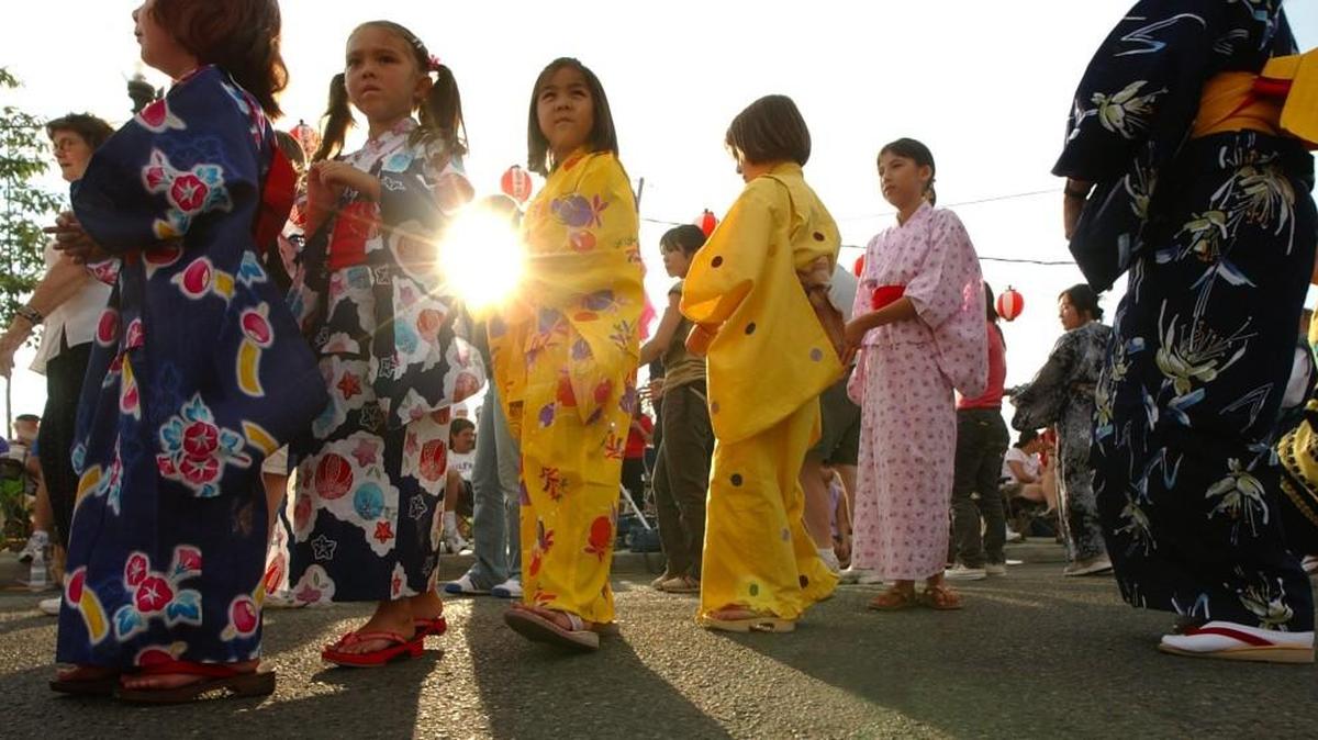 Dancers flow past the setting sun at a past Bon Odori Festival in downtown Olympia.
