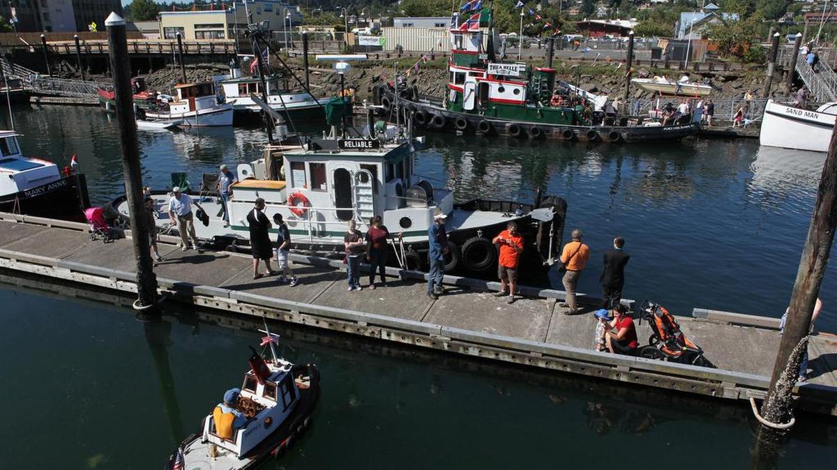 Families gather on the docks at Percival Landing to tour tugboats of all sizes — including the Smitty J, Reliable and Thea Belle — during the 2013 Harbor Days festival on the Olympia waterfront.