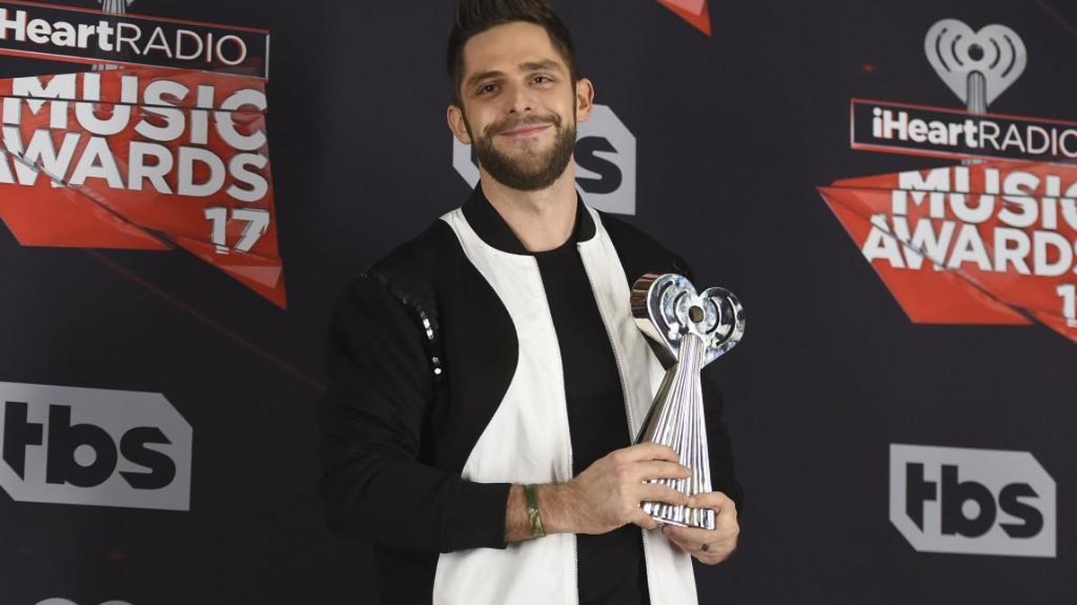 Thomas Rhett poses with the award for country artist of the year he received Sunday at the iHeartRadio Music Awards. Rhett will perform Sept. 20 at the Washington State Fair.