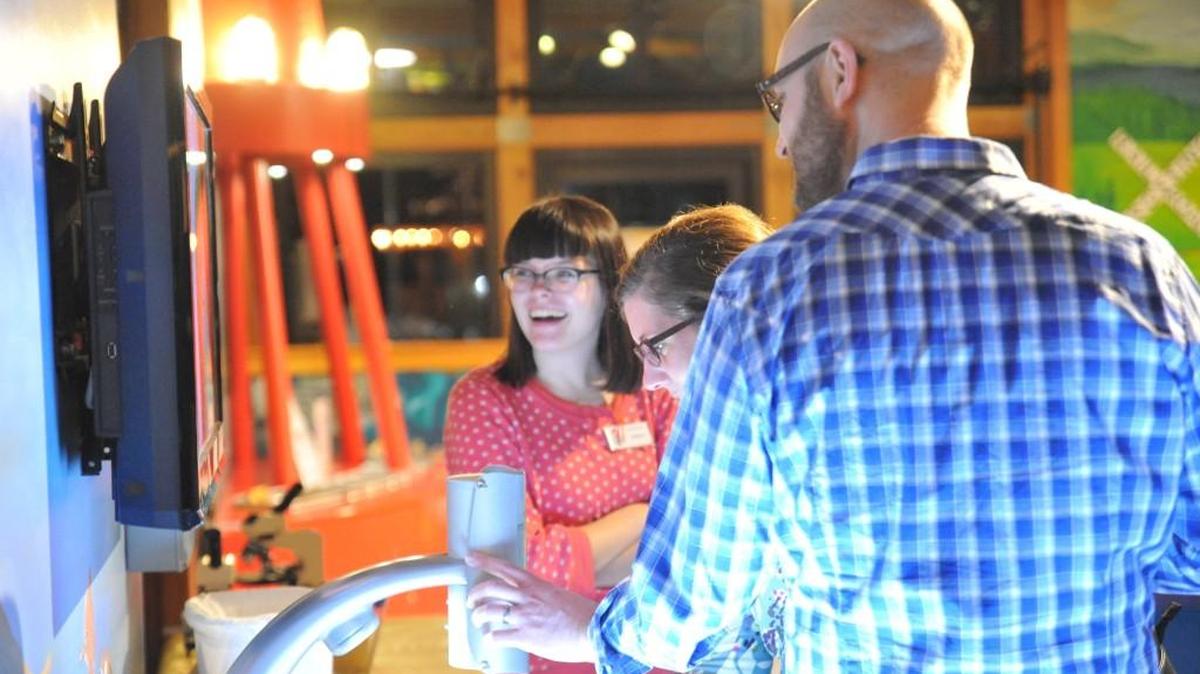 Adult Swim attendees explore the giant microscope at the science table.
