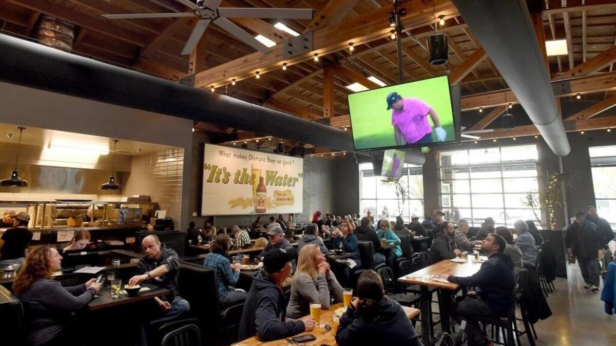 Both the bar and all-ages dining area are packed with patrons at Well 80 Brewhouse.