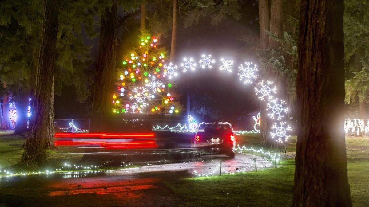 Cars slowly move through Pierce County’s Fantasy Lights in Spanaway Lake Park in 2014.