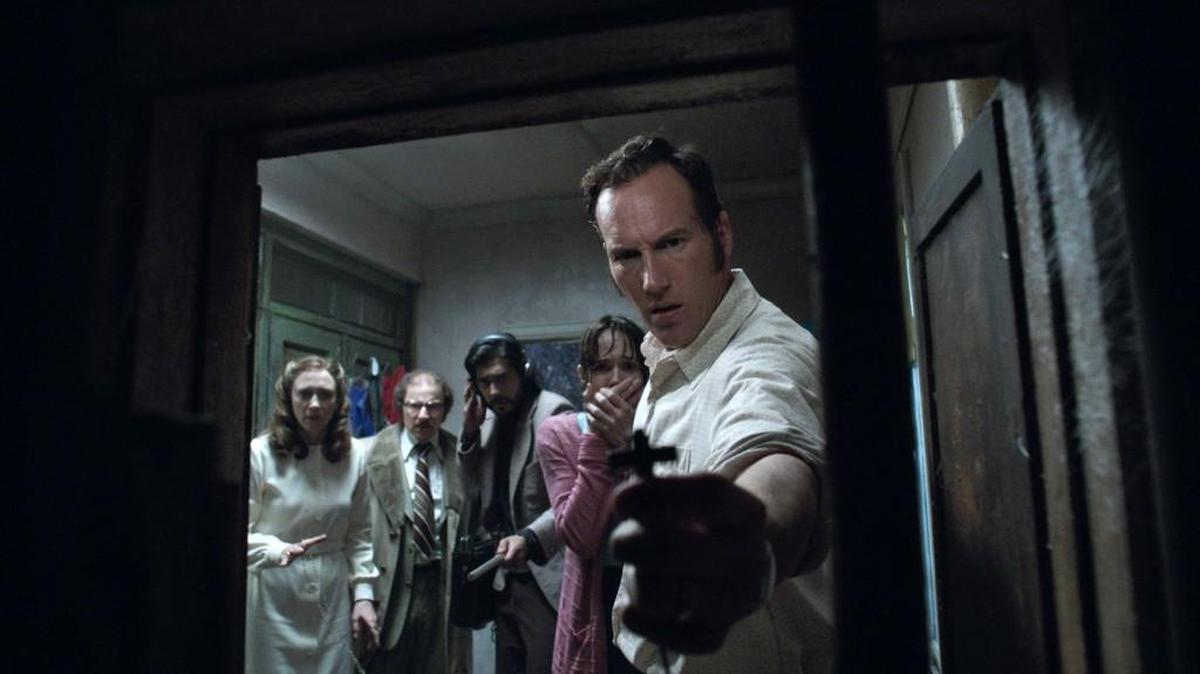 This image released by Warner Bros. shows, from left, Vera Farmiga, Simon McBurney, Abhi Sinha, Frances O'Connor and Patrick Wilson in a scene from the New Line Cinema thriller, "The Conjuring 2." (Warner Bros. via AP)