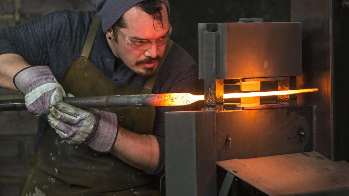 
Mareko Maumasi works on a weapon in May during production of the History Channel’s “Forged In Fire” at Brooklyn Fire Proof Stages in Williamsburg, N.Y. Maumasi will be in Monday’s episode.
