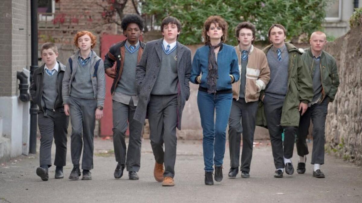 “Sing Street” follows Dublin’s Conor Lalor (Ferdia Walsh-Peelo, center left), whose comfortable teenage life has just been upended by his parent’s divorce. Lalor decides to start a band to impress the beautiful Raphina (Lucy Boynton, center right), and assembles a ragtag group of teenage misfits.