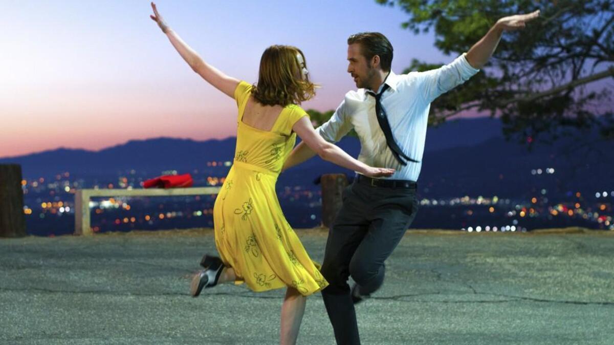 Emma Stone, left, and Ryan Gosling break out into song and dance at many moments throughout “La La Land.”