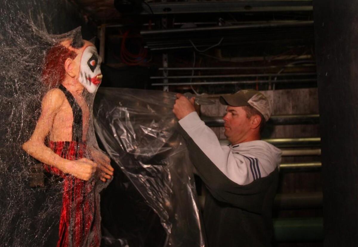 A crew member prepares a prop for My Morbid Mind haunted house in Lacey in 2010.