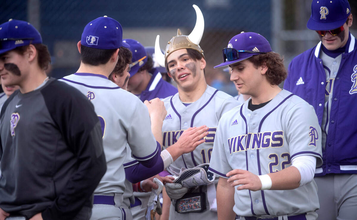 Puyallup’s Kai Halstead is welcomed by teammates after blasting a solor home run during Wednesday afternoon’s baseball game against the Olympia Bears at Olympia High School in Olympia, Washington, on April 12, 2023. Halstead went 3-3 with two home runs and four RBIs in Puyallup’s 6-2 victory.