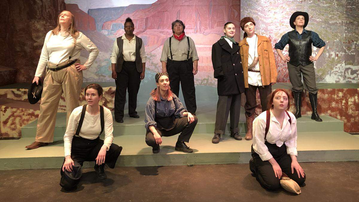 The women of Olympia Little Theater’s “Men on Boats.” Back row, left to right: Kendra Malm as “Walter Henry (Old Shady) Powell”, Andrea Weston-Smart as “Oramel (O.G.) Howland”, Susana Bailén Acevedo as “Seneca Howland”, Jesse Morrow as “John Wesley Powell”, Shannon Agostinelli as “William Dunn”, Heather R. Christopher as “John Colton Sumner.” Front row, left to right: Mariah Smith as “George Young Bradley”, Amy Shephard as “William Robert Hawkins”, Edith Campbell as “Andrew Hall.”