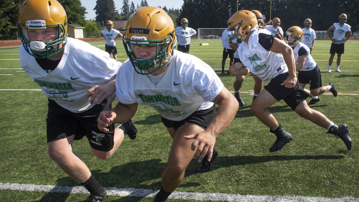 Tumwater junior guard Ayden Hurley (from left) and senior center Caden Hicks will be clearing the lanes from running backs like Gaven Murphy and Dylan Paine (far back right) during preaseason football practice at Tumwater High School on Friday, Aug. 17, 2018.