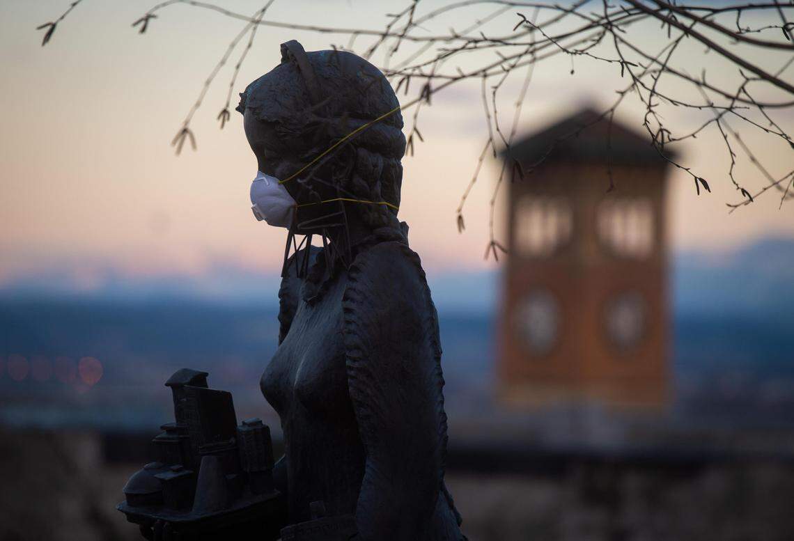 A mask is seen placed on the face of the “Goddess of Commerce” statue in Tacoma, Wash., on Saturday, March 14, 2020.