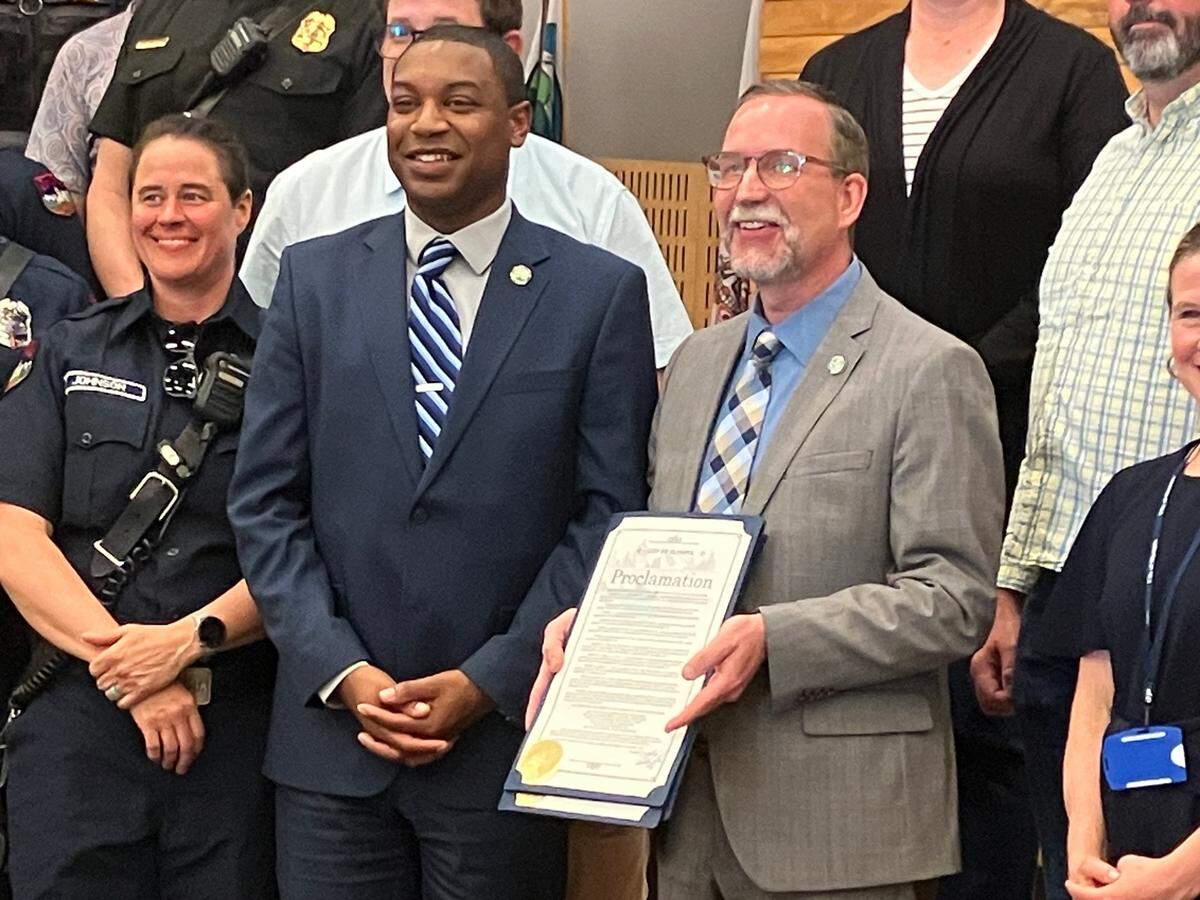 Olympia City Manager Jay Burney (right) and Mayor Dontae Payne pose for a photo following a proclamation that recognized public service and public employees at Tuesday’s council meeting.