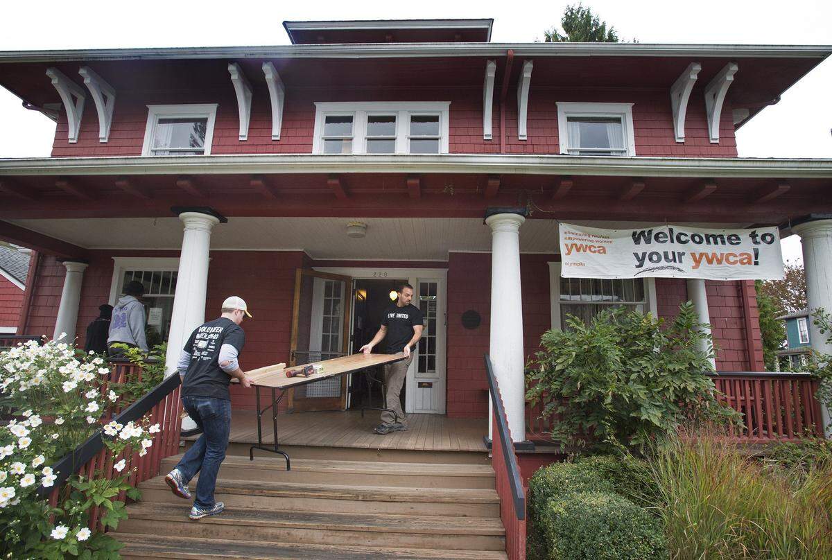 Casey Meehan (left) an independent health insurance broker from Lacey, helps Vernon Bonfield, owner the Washington Independent Health Insurance Agency, as the work on repairs to the YWCA main building in Olympia during the United Way of Thurston County’s 23rd annual Day of Caring on Friday, Sept. 25, 2015. Volunteers from the agency spent the day cleaning years of clutter, painting walls and repairing broken stairway railings. “I’m just blown away by this,” said Cherie Reeves Sperr, YWCA community engagement director. “I can’t get over how amazing this looks and how fresh it feels.” More than 600 people from 52 teams of volunteers pitched in on 35 projects in Thurston County’s single largest day of volunteerism.