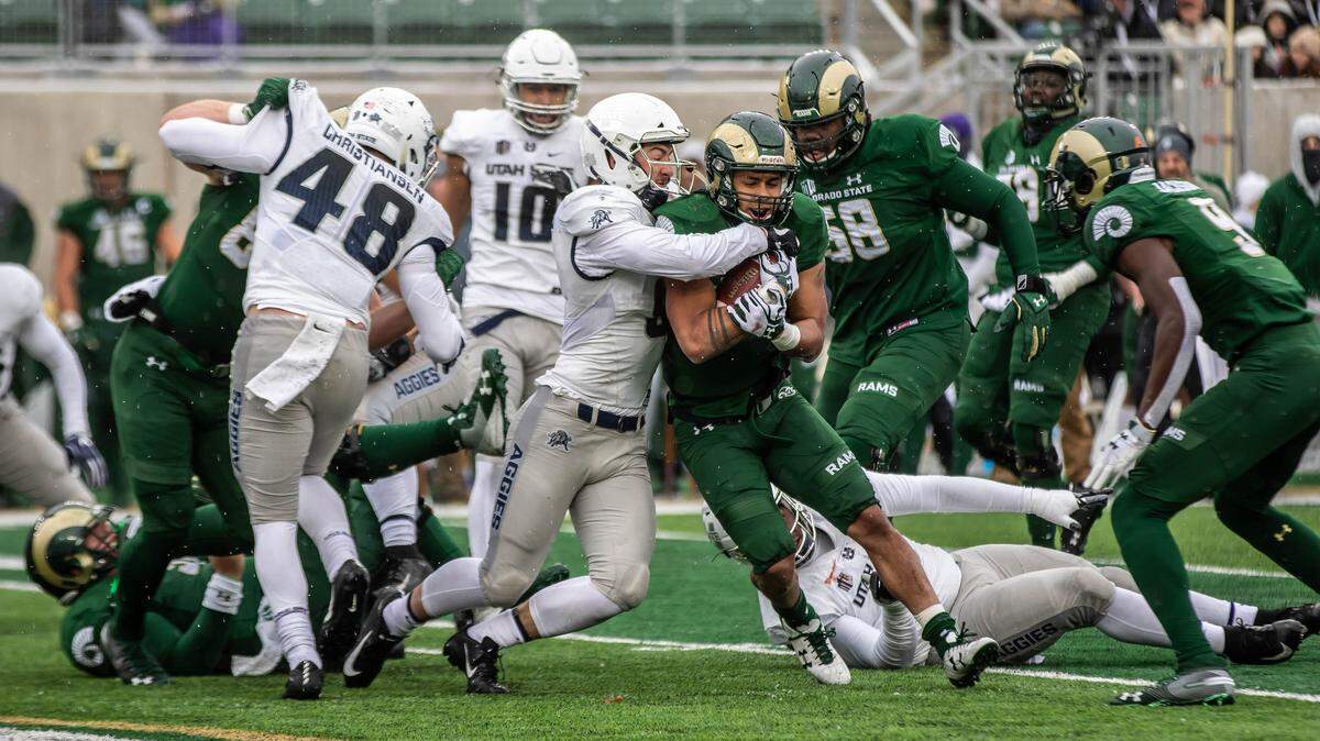 Utah State redshirt sophomore linebacker David Woodward tackles Colorado State senior running back Izzy Matthews in a Nov. 17 game. Woodward recorded a career-high 20 tackles in the Aggies’ 29-24 win.