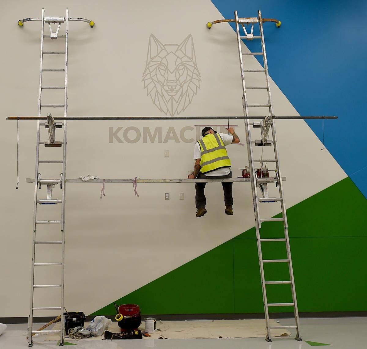 A man works on the “Komachin” in Komachin Middle School in an area that was previously a breezeway. It is now enclosed.