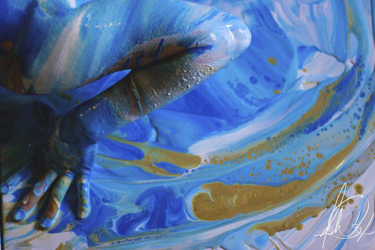 With a technique she calls “body pour,” Olympia artist Ash Cox takes the interaction of flesh and paint into the realm of performance art. At 3 p.m. Saturday at Gallery Boom, she’ll demonstrate the form, creating abstract art by pouring different colors onto the body of performer Veronica Franco.