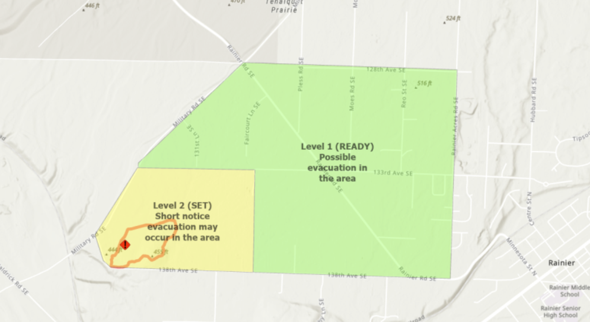 A wildfire prompted urgent evacuation orders for an area near Rainier Wednesday. Those orders were downgraded and their boundaries changed before 9 p.m.