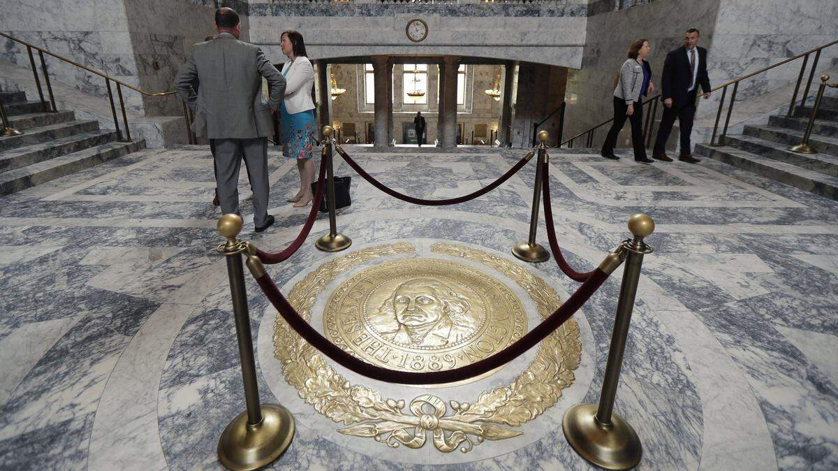 The Washington state seal is protected by ropes in the rotunda of the Legislative Building, Monday, April 22, 2019, at the Capitol in Olympia, Wash. Monday marked the start of the last week of the regular session of the Legislature. (AP Photo/Ted S. Warren)