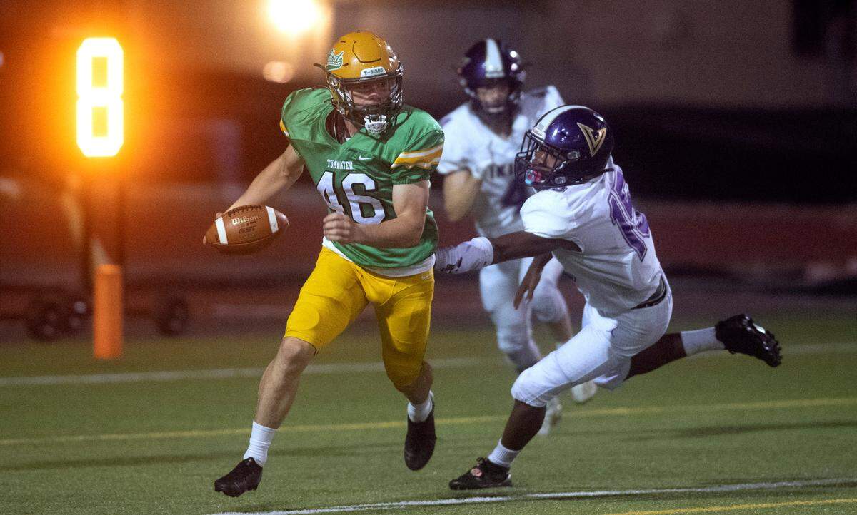 In the safety-saving play of the game, Tumwater punter Xavier Ickert carries a muffed snap punt out of the back of the end zone in front of North Kitsap defensive back Morgan Paul during Friday night’s 2A football game at Tumwater District Stadium in Tumwater, Washington, on Sept. 9, 2022. Tumwater won the game, 8-6.