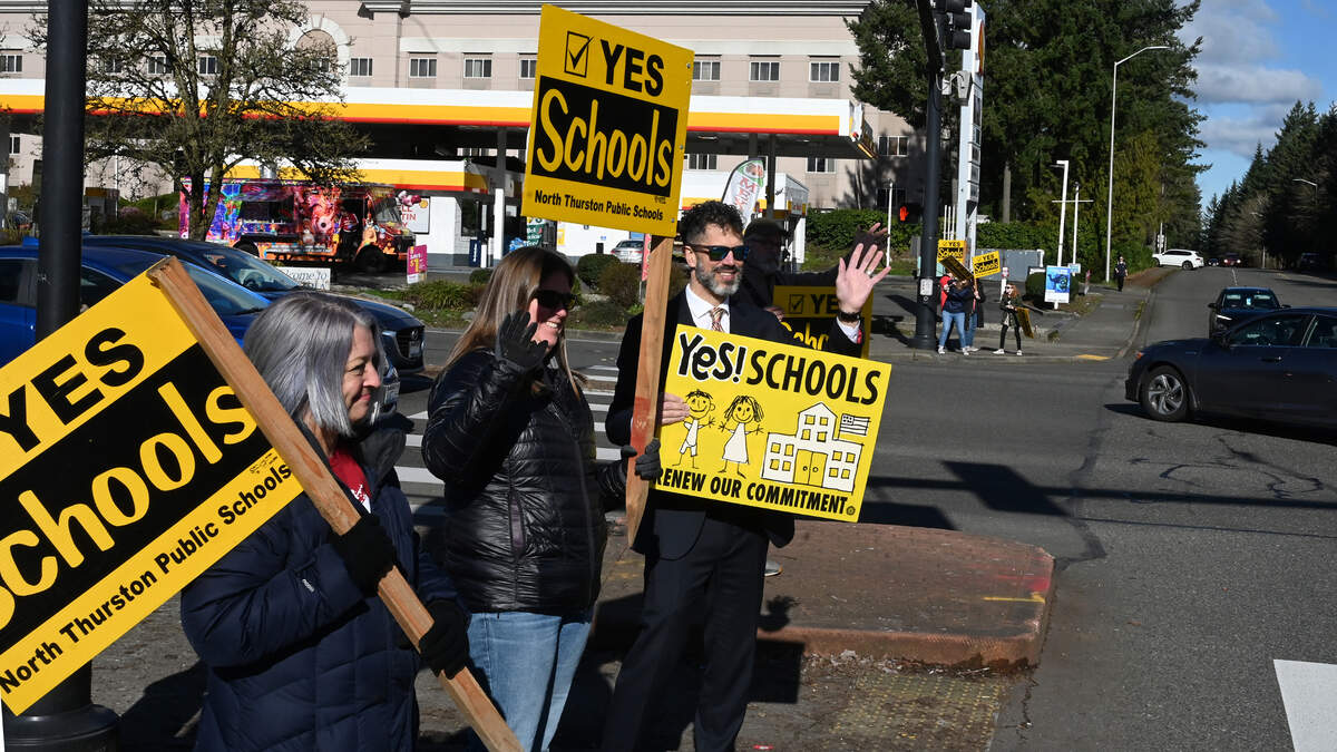 Supporters for the North Thurston Public Schools’ February levy gather at the busy intersection of Martin Way East and College St SE in Lacey, Wa. on Saturday, Feb. 10 as a reminder to passing motorists of the Tuesday voting deadline.