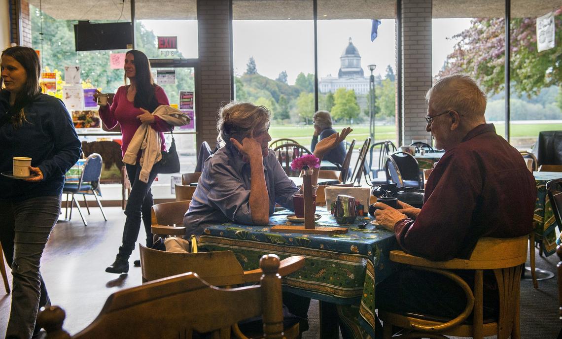 Candace Vogler and Peter Ingersoll “discuss all the important things in the world” over coffee at Traditions Cafe in downtown Olympia.