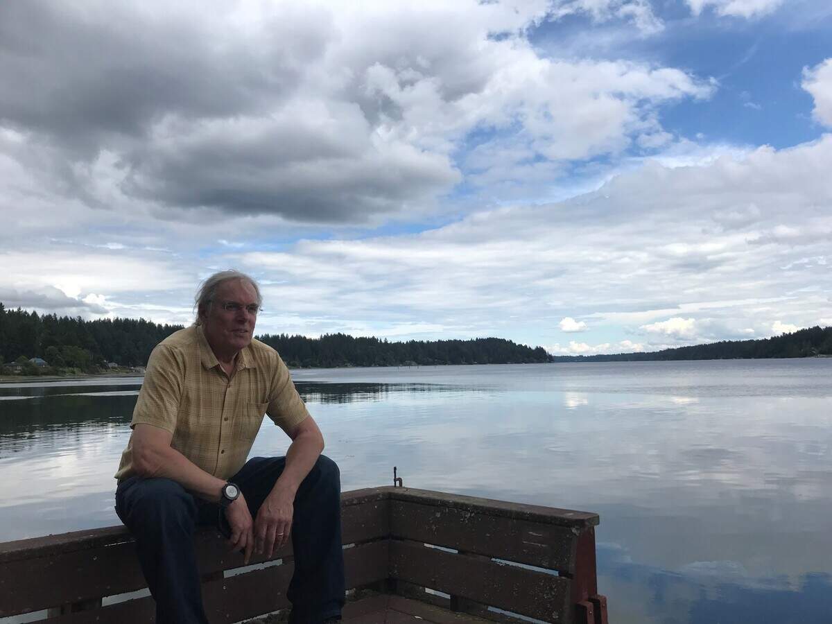 Bruce Dyer, Tom Dyer’s brother, sits by the shores of Mud Bay, the ancestral home of the Dyers and the subject of several songs on the album.