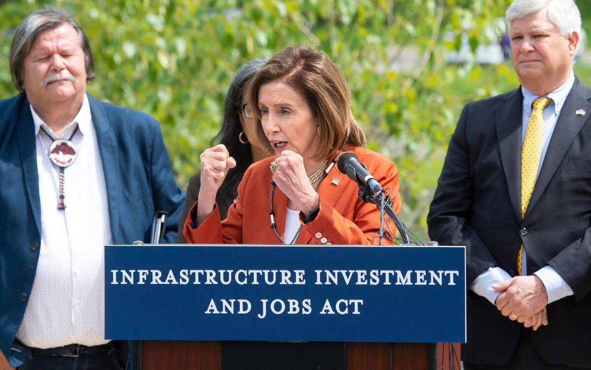 Speaker of the U.S. House of Representatives Nancy Pelosi puts up her fists as she describes the tenacity of Ukraine president Volodymyr Zelenskyy during questions at the Infrastructure Investment and Jobs Act press conference in front of the Chambers Creek Dam in University Place on Wednesday, May 4.
