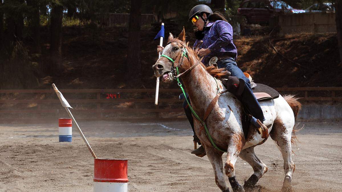 Levi Cantrell from the Blazing Saddles 4-H Club competes in the 2-Barrel Flag Competition with his horse Buddy during the equine events Sunday, Aug. 1, 2021 at the Thurston County Fairgrounds.
