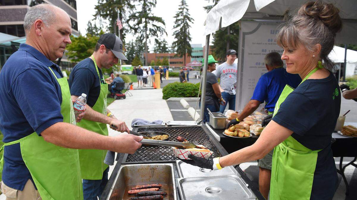 Gateway Rotary members Tim Braniff, Michael Buchanan, Ed Schlich and Michelle Wickett (left-right) keep the links moving at a previous Brats, Brews and Bands Festival at the Hub complex in Lacey. Sponsored by the Gateway Rotary Club the festival featured music ranging from country to rock and soul, with over a dozen craft beers on tap.