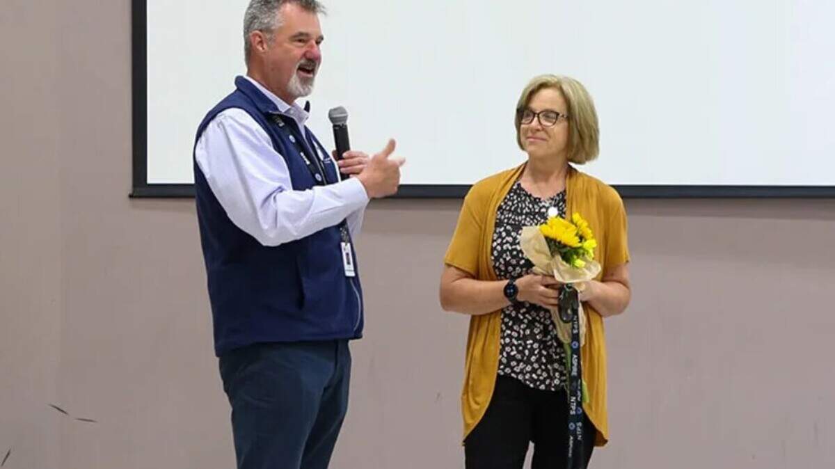 Aspire Middle School math teacher Jaqui Gibbons is shown here with North Thurston Public Schools Superintendent Troy Oliver during a surprise assembly to announce that she is the Regional Teacher of the Year.