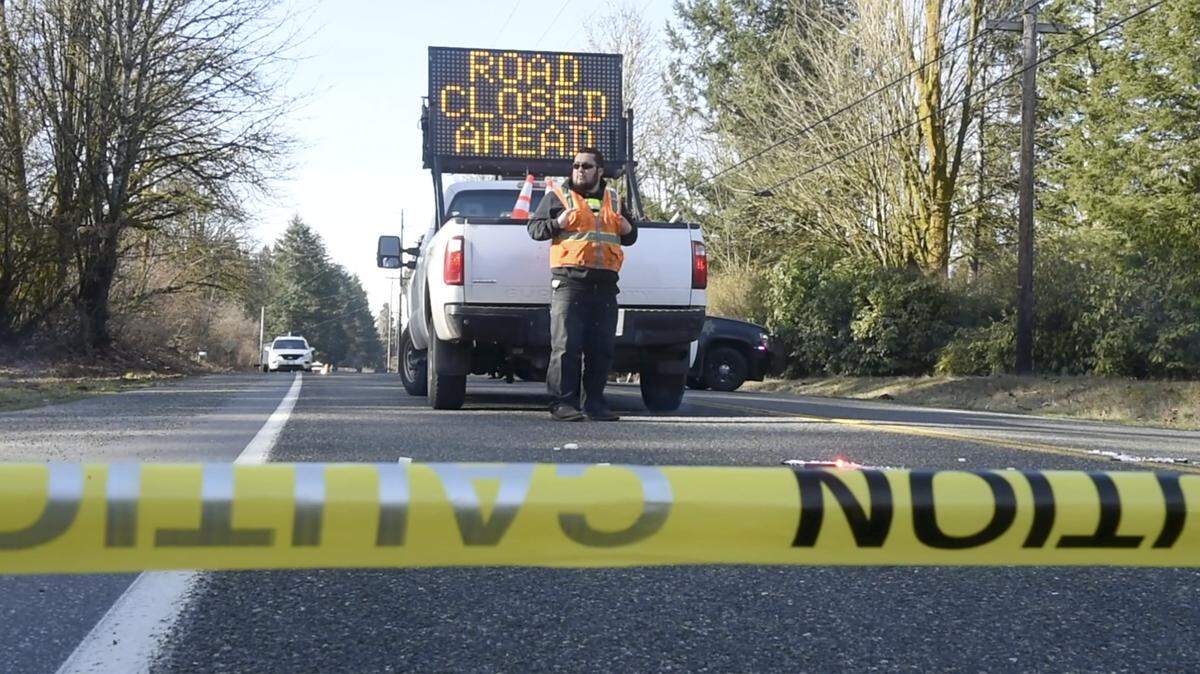 A Thurston County Sheriff’s Deputy redirects traffic around the fatal crash investigation on Littlerock Road near 81st Avenue south of Tumwater on Friday, March 15, 2019.