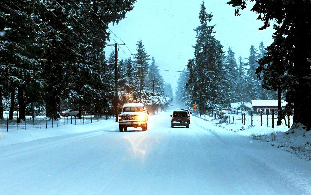 A slick sheen of ice coated most of Rainier Road Southeast late Sunday afternoon, making travel treacherous between Lacey and Rainier.