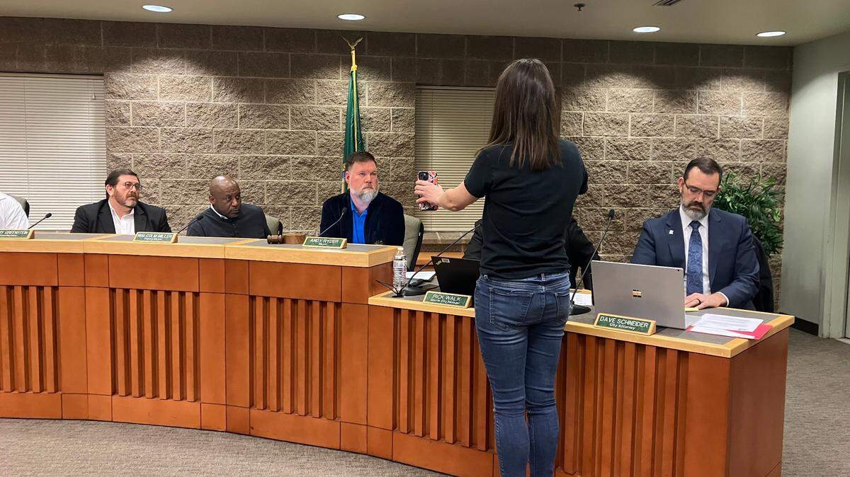 North Thurston parent Stephanie Scott shows a video to Lacey Mayor Andy Ryder of what she says was a confrontation between an administrator and student during last year’s protests at area high schools.